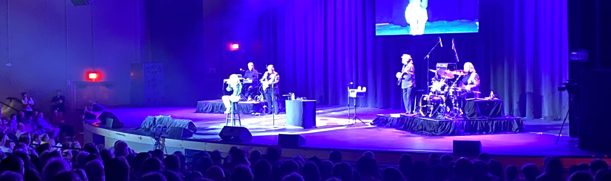 signer on stage in chair washed out by the lights Cincinnati